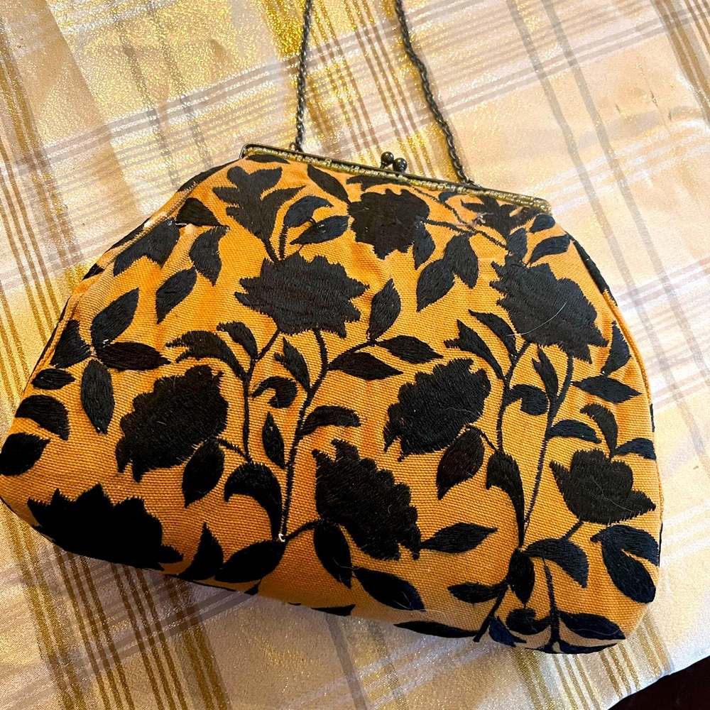 Vintage purse with chain handle very roomy inside with a snap closure.
